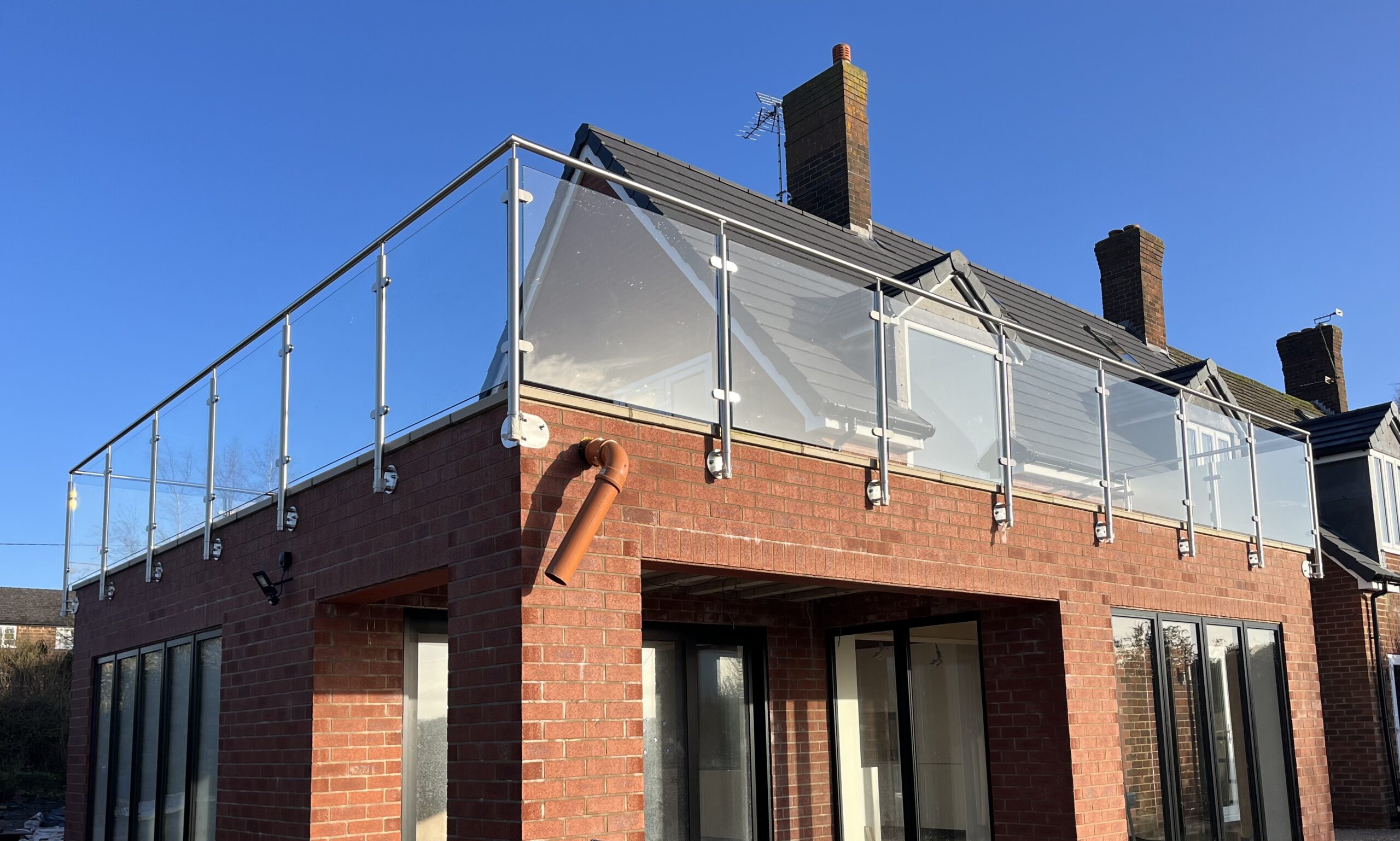 image0 Close-up view of a side-mounted stainless steel glass balustrade, showcasing durable spigots and toughened glass for a secure, modern design.