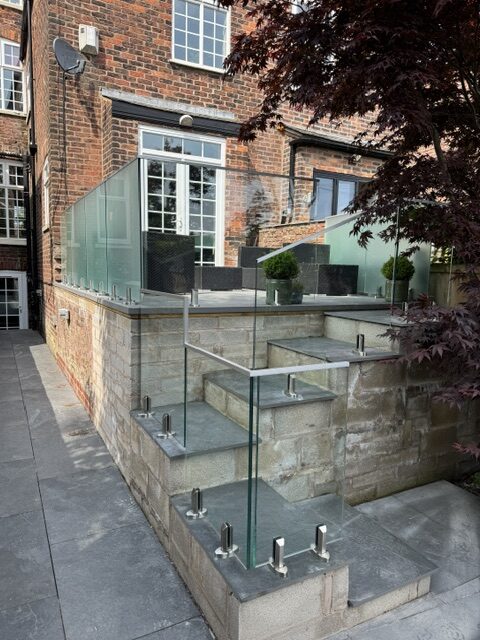 Professional glass balustrade installation Salford - structural spigot mounting system with privacy screening by NW Fabrications North West