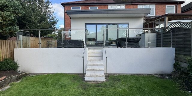 chadderton_front 316-grade stainless steel framed balustrade with self-closing glass gate installation in Chadderton by NW Fabrications ``` **Option 2 (118 characters - more descriptive):** ``` Stainless steel framed glass balustrade with magnetic self-closing gate and handrail installed in Chadderton garden ``` **Option 3 (107 characters - location focused):** ``` Modern stainless steel and glass balustrade system with self-closing gate installed in Chadderton, Oldham