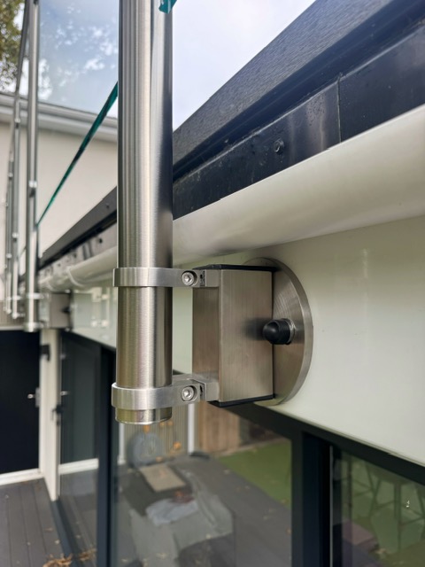 Close-up of long reach side-mounted balustrade bracket showing 130mm extended clearance from fascia for gutter clearance